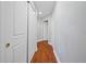 Hallway features wood flooring and white doors leading to various rooms in the house at 1209 E Cumberland Ave # 508, Tampa, FL 33602