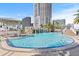 Community pool features a rock waterfall, palm trees and lounge area, with city views at 1209 E Cumberland Ave # 508, Tampa, FL 33602