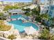 This is an aerial view of the stylish, resort-like pool area with palm trees, a waterfall and city views at 1209 E Cumberland Ave # 508, Tampa, FL 33602