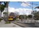 Bright street view of vintage trolleys, lush landscaping, and modern architecture, creating a vibrant scene at 1209 E Cumberland Ave # 508, Tampa, FL 33602