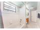 Clean bathroom with white tile, bathtub, and shower at 270 Pinewinds Blvd, Oldsmar, FL 34677