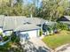 Exterior view of a charming house with a two car garage at 270 Pinewinds Blvd, Oldsmar, FL 34677