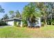 House exterior with lush landscaping and palm tree at 270 Pinewinds Blvd, Oldsmar, FL 34677