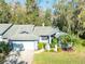 Exterior view of a charming house with a two car garage at 270 Pinewinds Blvd, Oldsmar, FL 34677