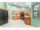 Bright kitchen with wood cabinets, black appliances, and tile floor at 270 Pinewinds Blvd, Oldsmar, FL 34677