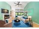 Cozy living room featuring a fireplace, vaulted ceilings, and bright blue accent colors at 270 Pinewinds Blvd, Oldsmar, FL 34677