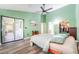 Main bedroom with wood floors, ceiling fan, and access to patio at 270 Pinewinds Blvd, Oldsmar, FL 34677