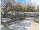 Gray house with wooden fence and driveway, surrounded by large trees at 2820 W Leila Ave, Tampa, FL 33611