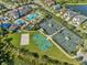 Aerial view of community amenities including pools, tennis courts, and a playground at 30200 Southernwood Ct, Wesley Chapel, FL 33543