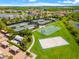 Aerial view showing tennis courts, basketball court, and sand volleyball court at 30200 Southernwood Ct, Wesley Chapel, FL 33543