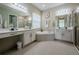 Large bathroom with double sinks, soaking tub, and walk-in shower at 30200 Southernwood Ct, Wesley Chapel, FL 33543