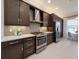 Modern kitchen with stainless steel appliances and dark brown cabinets at 30200 Southernwood Ct, Wesley Chapel, FL 33543