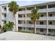 Exterior of condo building showcasing balconies and palm trees at 1524 Lakeview Rd # 103, Clearwater, FL 33756