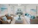 Spacious living room with light-colored furniture and coastal decor at 1524 Lakeview Rd # 103, Clearwater, FL 33756