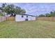 Spacious backyard with a large grassy area and wooden fence at 4008 W Olive St, Tampa, FL 33616