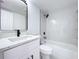 Updated bathroom with white vanity, quartz countertop, and bathtub at 4008 W Olive St, Tampa, FL 33616