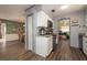 Kitchen with white cabinets, granite countertops, and view into dining area at 809 41St N Ave, St Petersburg, FL 33703