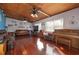 Bright living room featuring hardwood floors, wood ceiling beams, and a vintage piano at 809 41St N Ave, St Petersburg, FL 33703