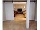 Spacious basement Gathering room with tile floors and barn doors at 12500 Merry Ln, Hudson, FL 34667