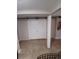 View of basement with white barn doors and tile flooring at 12500 Merry Ln, Hudson, FL 34667