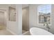 Modern bathroom with a walk-in shower and free-standing tub at 12823 Daleridge Pl, Riverview, FL 33579