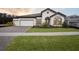 Two-story home with a three-car garage and landscaped front yard at 12823 Daleridge Pl, Riverview, FL 33579