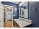 Stylish bathroom with marble countertop and illuminated vanity mirror at 5101 W Platt St, Tampa, FL 33609