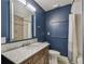 Modern bathroom with marble vanity, blue walls, and updated fixtures at 5101 W Platt St, Tampa, FL 33609