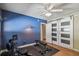 Bright bedroom with hardwood floors, barn doors, and space for fitness equipment at 5101 W Platt St, Tampa, FL 33609