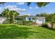 Single story home with tropical landscaping and lush green lawn at 5101 W Platt St, Tampa, FL 33609