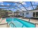 Inviting screened pool area with lounge chairs and outdoor dining space at 5101 W Platt St, Tampa, FL 33609