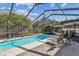 Inviting screened pool area with lounge chairs and patio at 5101 W Platt St, Tampa, FL 33609