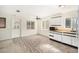 Open-concept kitchen with updated flooring, white cabinets, and natural lighting at 6611 14Th N St, St Petersburg, FL 33702