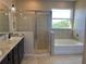 Bathroom with walk-in shower and bathtub at 1027 Ocean Spray Dr, Ruskin, FL 33570