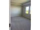 Spacious bedroom with neutral colored carpet and large windows at 1027 Ocean Spray Dr, Ruskin, FL 33570