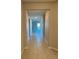 Bright hallway with tile floors, leading to various rooms at 1027 Ocean Spray Dr, Ruskin, FL 33570