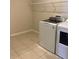 Bright laundry room with washer, dryer, and overhead shelving at 1027 Ocean Spray Dr, Ruskin, FL 33570