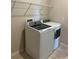 Laundry room features a washer, dryer, and ample shelving at 1027 Ocean Spray Dr, Ruskin, FL 33570