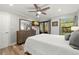Bedroom with a king-size bed, large mirror, and balcony access at 104 Cypress Pond Rd, Palm Harbor, FL 34683