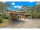 Condo building with covered parking and mature trees at 104 Cypress Pond Rd, Palm Harbor, FL 34683