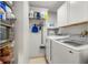 Utility room includes full-size washer and dryer, shelving, and storage at 104 Cypress Pond Rd, Palm Harbor, FL 34683