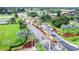 Community entrance featuring landscaped roadways, palm trees, and various amenities in a lush environment at 2104 Hembury Pl # 33, Sun City Center, FL 33573