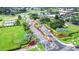 An aerial view featuring the community entrance, showcasing landscaped roadways, palm trees, and various amenities in a lush environment at 2104 Hembury Pl # 33, Sun City Center, FL 33573