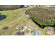An aerial showcases the community with ponds, lush trees, and several homes at 2104 Hembury Pl # 33, Sun City Center, FL 33573