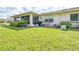 Large backyard with grassy lawn and screened porch at 2104 Hembury Pl # 33, Sun City Center, FL 33573