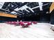 Large ballroom with hardwood floors, stage, and tables with red chairs, perfect for events at 2104 Hembury Pl # 33, Sun City Center, FL 33573