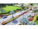 Community entrance featuring landscaped roadways, palm trees, and various amenities in a lush environment at 2104 Hembury Pl # 33, Sun City Center, FL 33573