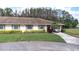 Beautiful single-story home with a carport, well-manicured lawn, and vibrant landscaping at 2104 Hembury Pl # 33, Sun City Center, FL 33573