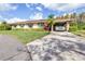 Charming single-story home with a well-manicured lawn, a carport, and beautiful landscaping at 2104 Hembury Pl # 33, Sun City Center, FL 33573