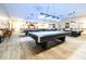 Bright game room featuring multiple billiard tables under pendant lights with ample seating at 2104 Hembury Pl # 33, Sun City Center, FL 33573